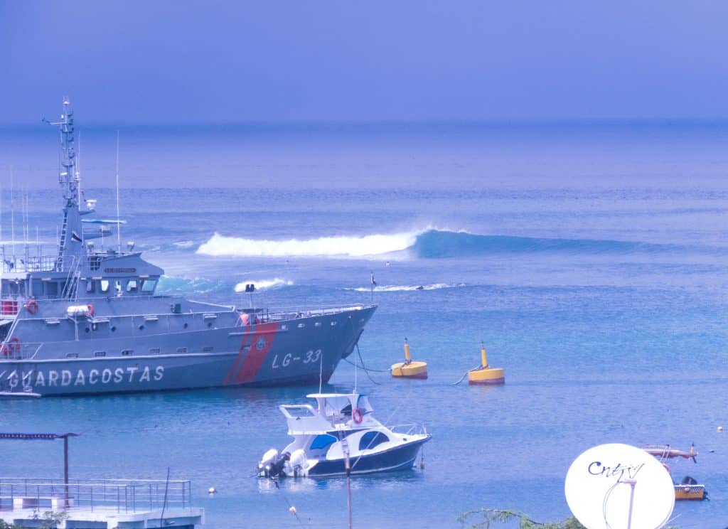 Left hander wave peeling off in front of a coast guard ship