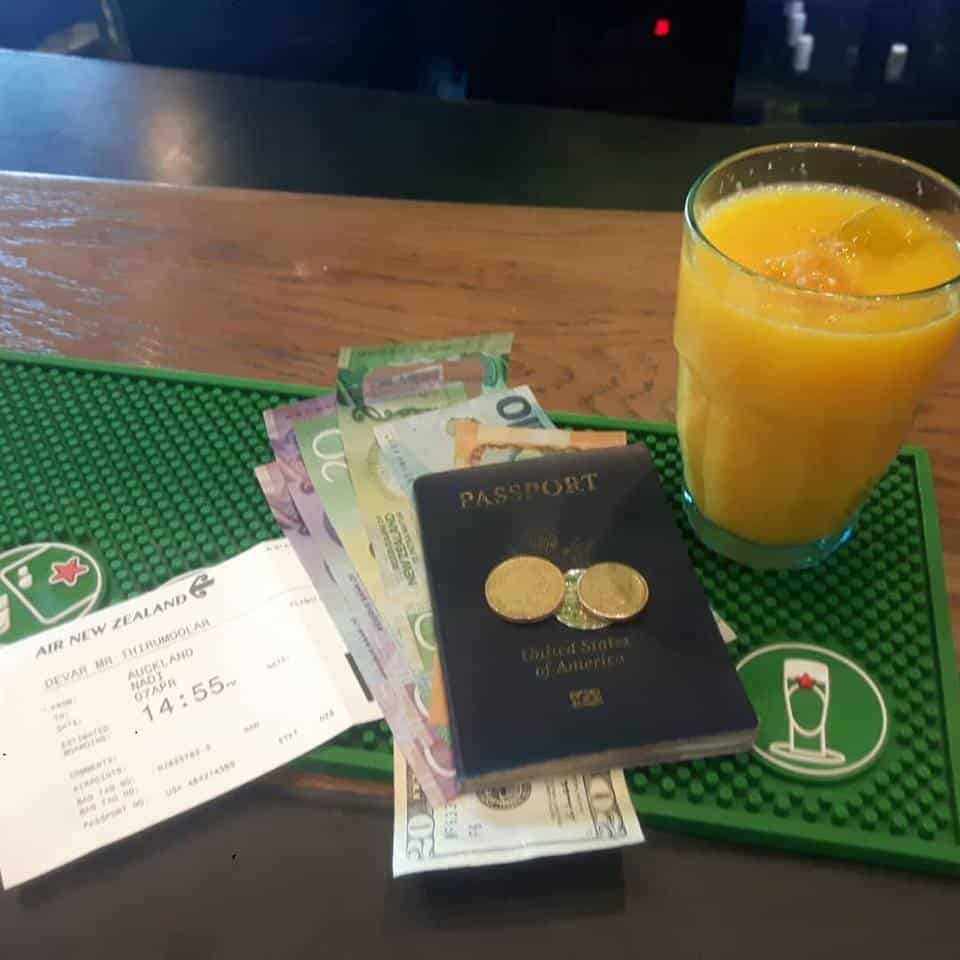 My Passport, Money, Boarding Pass, and an OJ & Rum at the Departure Lounge, leaving Auckland, New Zealand