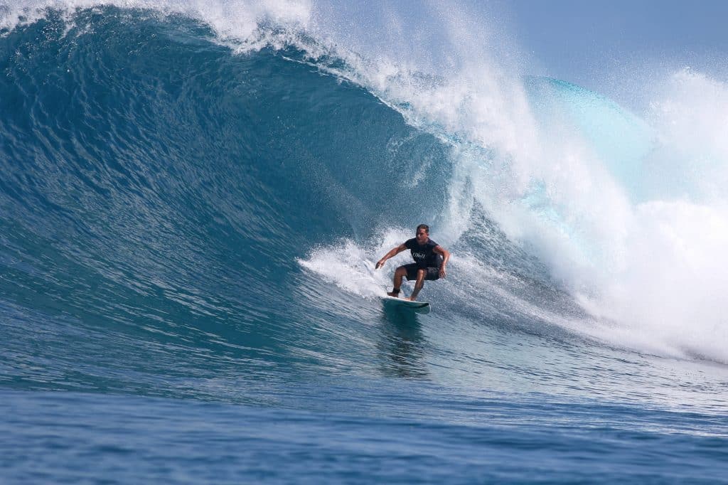 Surfing a big right in the Maldives
