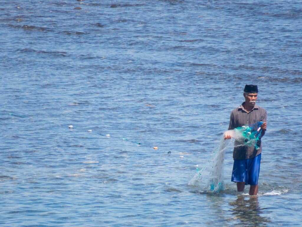 Networking Fisherman walking With His Net